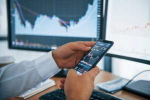 businessman-is-in-office-with-multiple-screens-conception-of-exchange-and-money